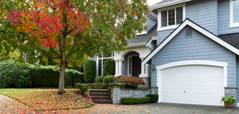 A summer home with a tree just starting to turn for the autumn seasons. | Select Home Warranty