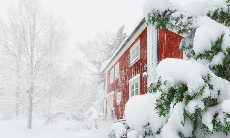 A rural red home in the middle of a snow storm. | SHW Blog