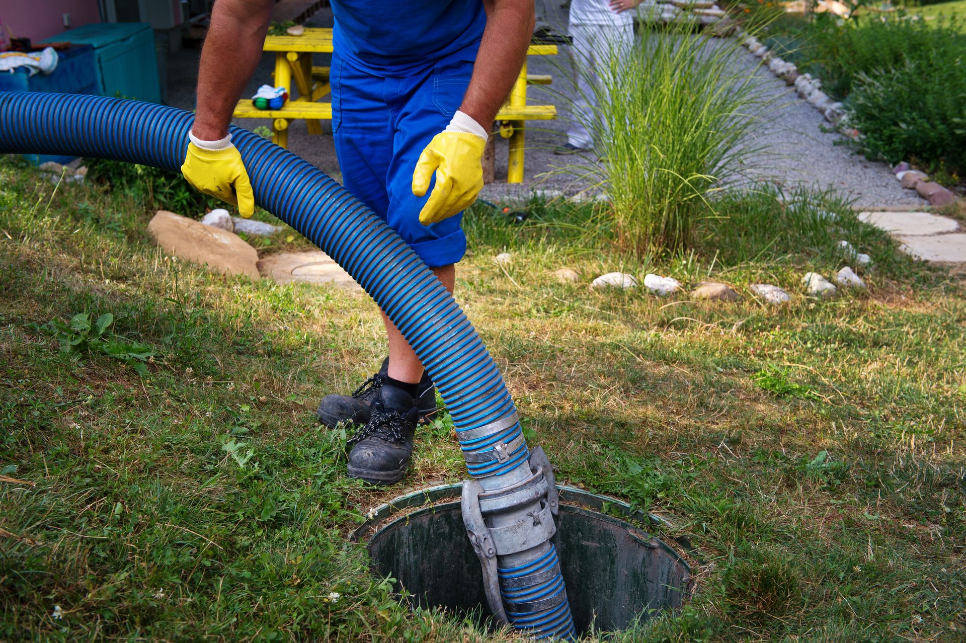 Professional pumping a septic tank. In addition to a septic system warranty, proper care and maintenance are important for your septic system.