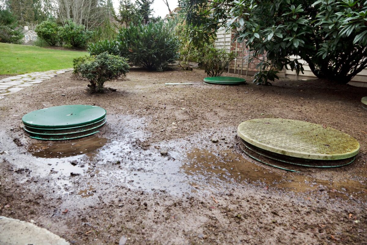 Water pooling around the top of a septic system. A septic system warranty can help with repair costs and prevent this from happening.