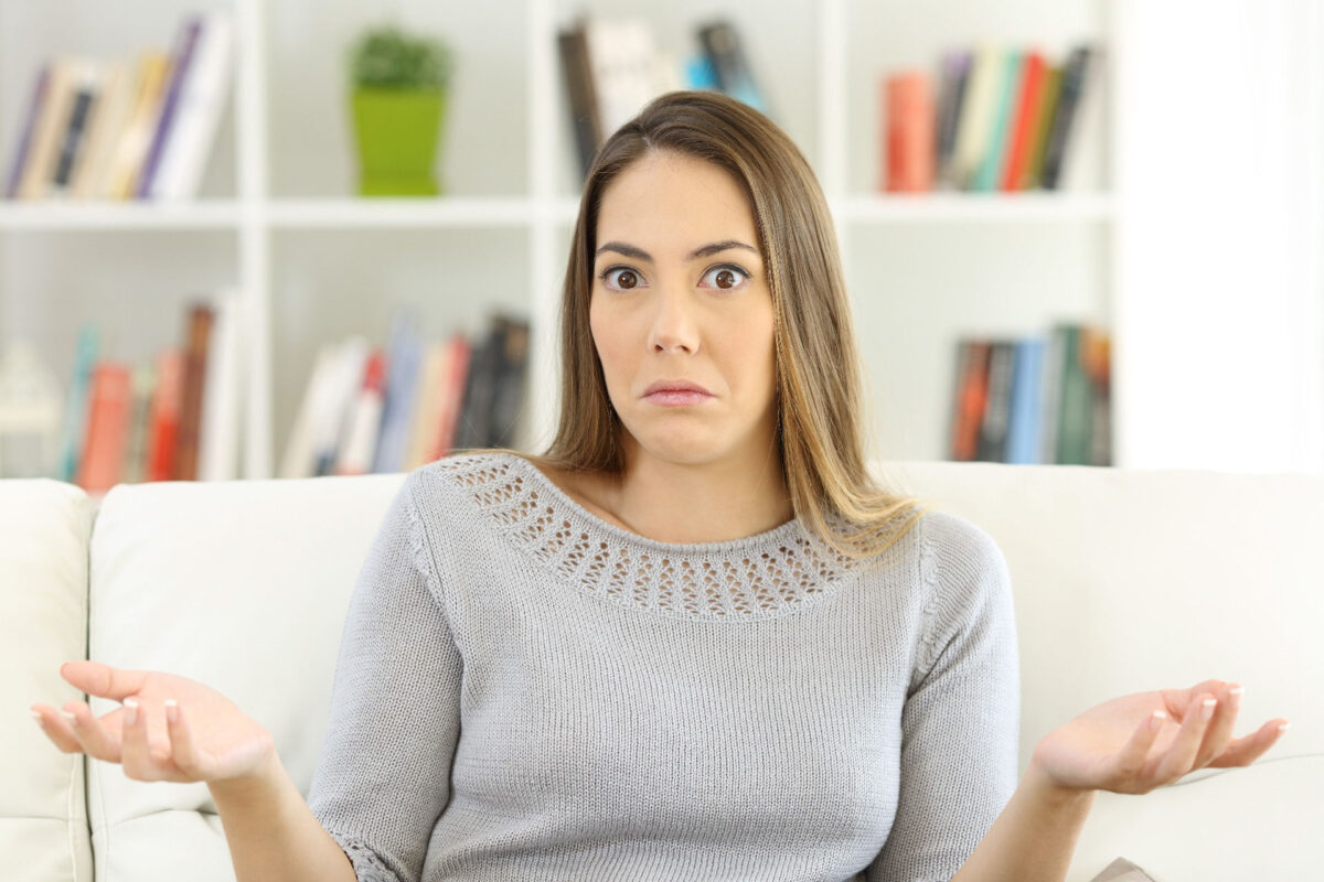 Woman shrugging, wondering about home warranty benefits.