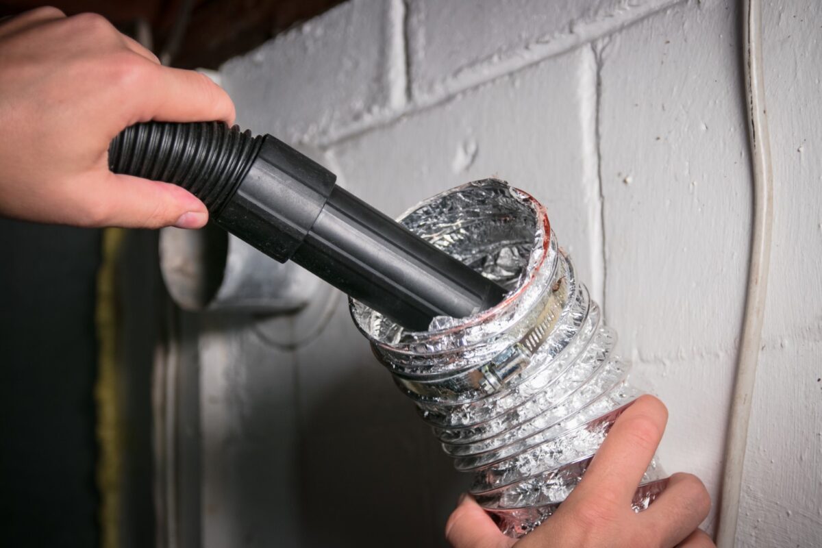 Vacuum cleaning a flexible aluminum dryer vent hose, to remove lint, dust, and dirt.