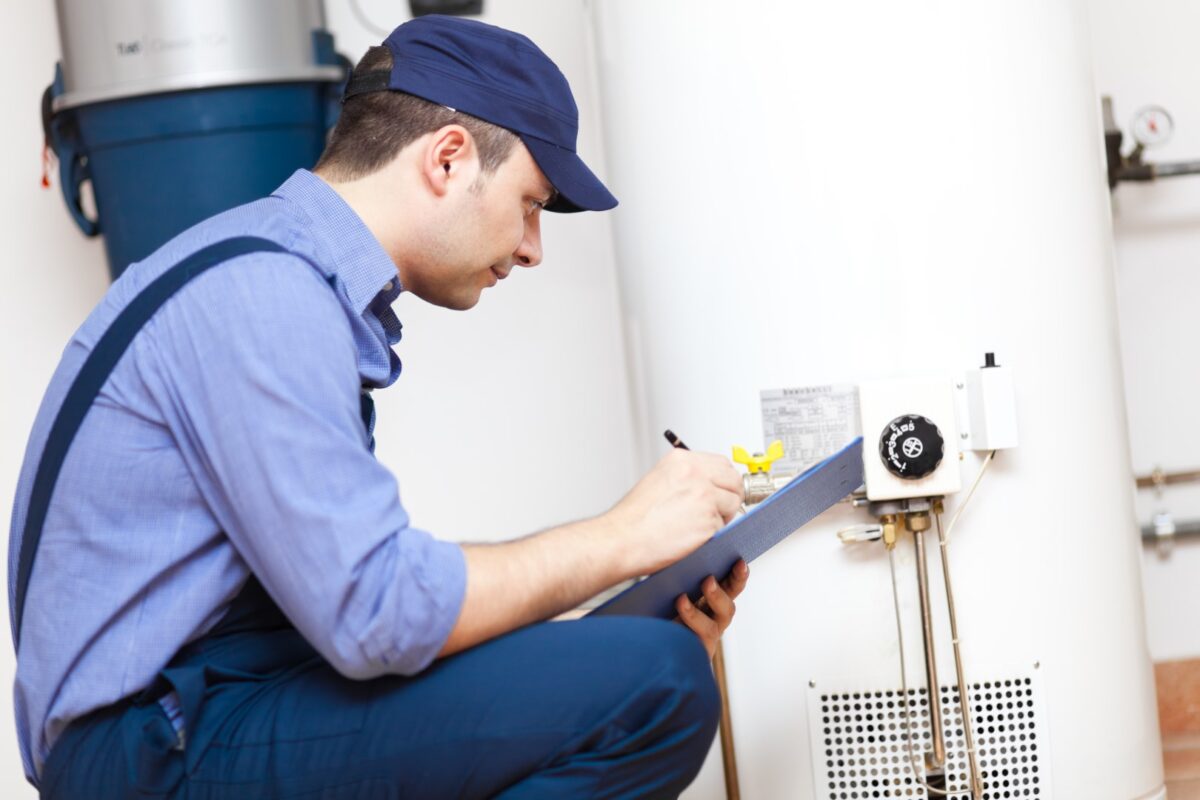 Plumber working on a water heater.